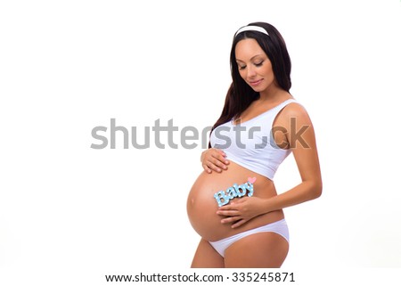 Happy pregnancy. Pregnant woman waiting for the firstborn. Blue label "Baby" for newborn boy  near tummy