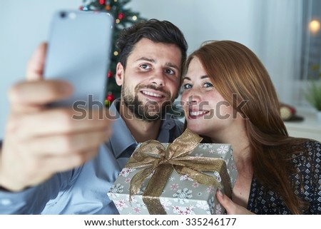 young happy couple hug and love christmas in front of grey background