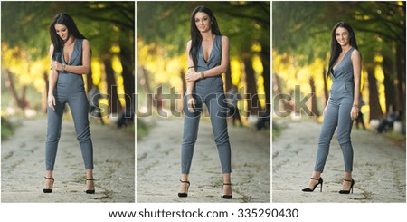 Beautiful woman in gray posing in autumnal park. Young brunette woman spending time during autumn in forest. Long dark hair attractive woman wearing a gray tight outfit, outdoors shot