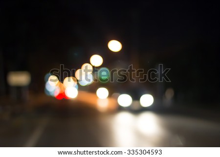 Abstract blurry traffic road bokeh light view from inside a car