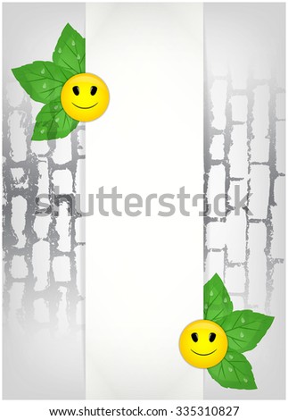 Sheet of paper and green leaves with smiles on brick wall