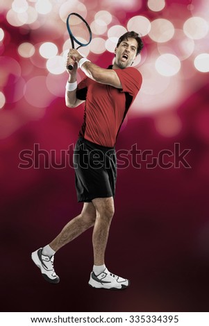 Tennis player with a red shirt, playing on red lights background.