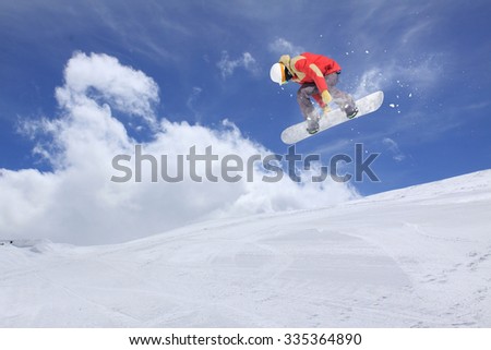 Flying snowboarder on mountains, extreme sport Royalty-Free Stock Photo #335364890