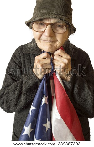 Senior woman holding an American flag, selective focus.