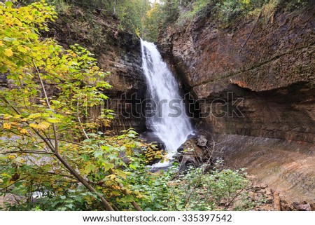 Miners Falls at Pictured Rocks National Lakeshore - Upper Peninsula of Michigan. Miners Falls cascades over rock face and rushes over moss covered boulders on its path to Lake Superior.