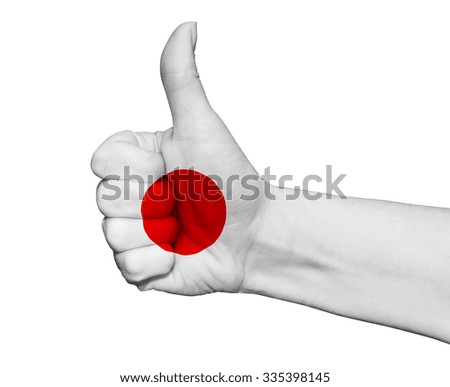 Hand with thumb up painted in colors of Japan flag isolated on white background