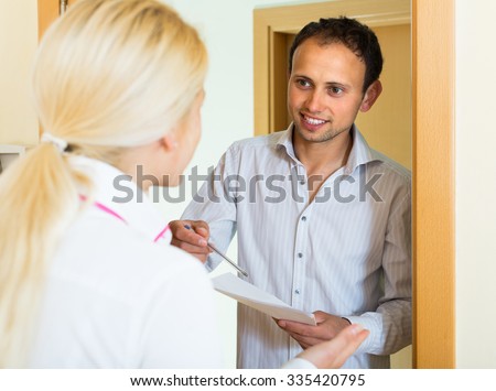 Communal services employee asking tenant to sign a document
