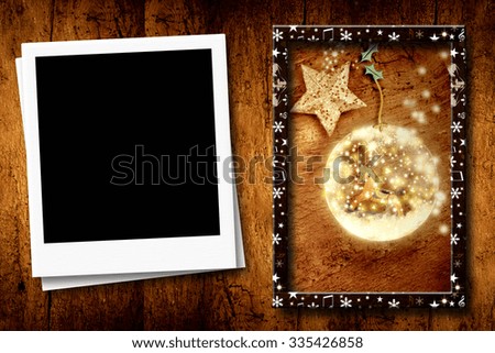 Christmas postcard with one empty  frame for photo and Christmas picture on wooden background