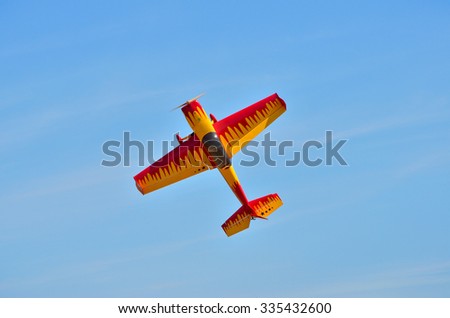 Flying the plane performs aerobatics in the sky Royalty-Free Stock Photo #335432600