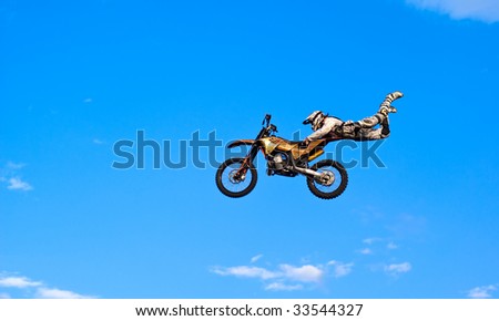 flying biker on a blue sky background