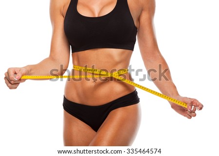 Beautiful sporty woman body with yellow measure on white background.