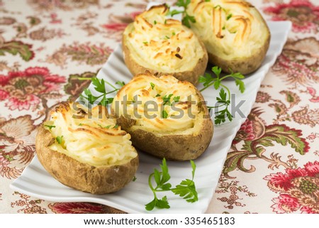 Close up of creamy garlic  baked potatoes for Thanksgiving table. Royalty-Free Stock Photo #335465183