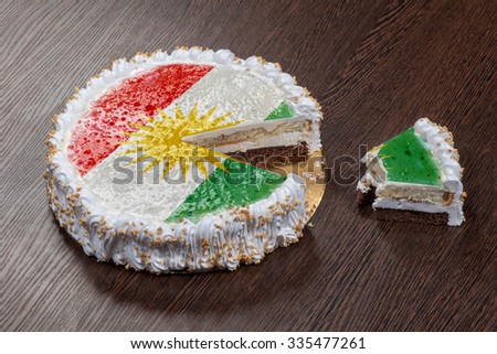 The symbol of war and separatism: a cake with a picture of the flag of Kurdistan is broken into pieces
