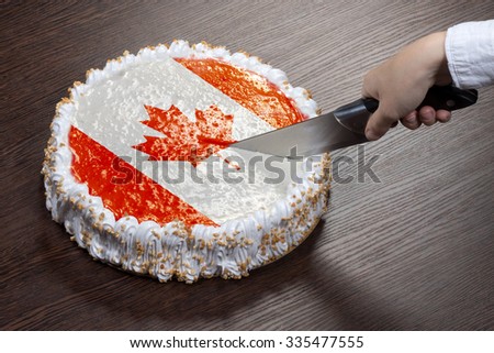 The symbol of war and separatism: a cake with a picture of the flag of Canada is broken into pieces