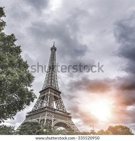 Dramatic cloudy sky above Eiffel Tower in Paris, France. Toned photo.