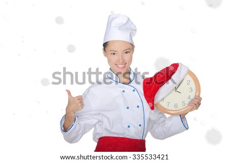 beautiful asian chef with clock and Christmas hat in falling snow