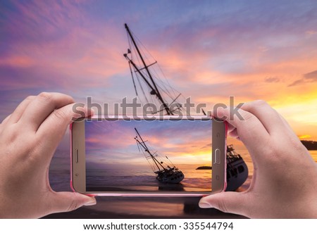 Image of shooting photographs with smartphone on the beach sunset, Photographer holding mobile smart phone with photograph and photography
