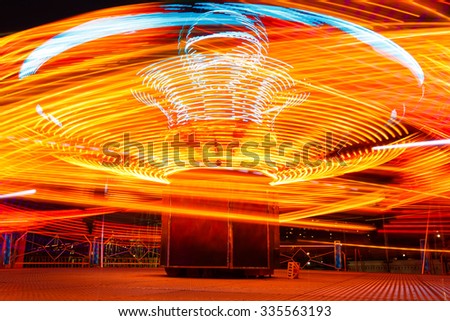 Evening picture carousel in an amusement park at autumn time