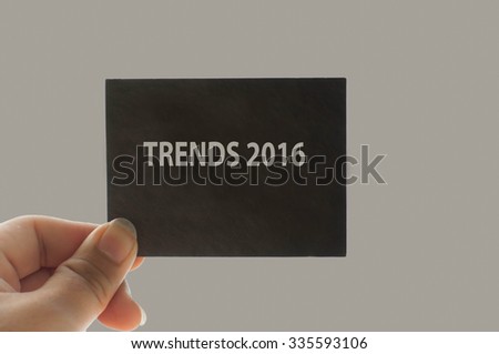 TRENDS 2016 message on the card shown by a man, vintage tone