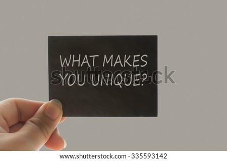 WHAT MAKES YOU UNIQUE? message on the card shown by a man, vinta
