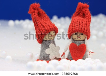 Cute dolls on winter background