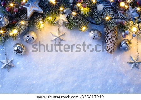 Christmas background with a silver ornament, christmas stars, berries and fir in snow 