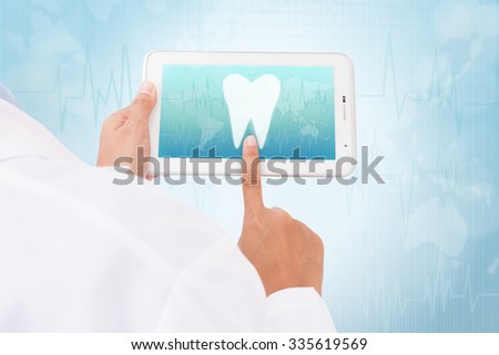Doctor hand touch screen Tooth symbol on a tablet. medical icon