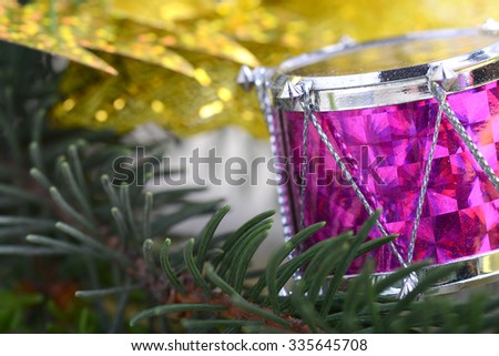 Christmas background with drums, green eve tree branch, golden new year decoration 