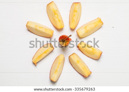 Delicious Red Apple Slices on a wooden White Background 