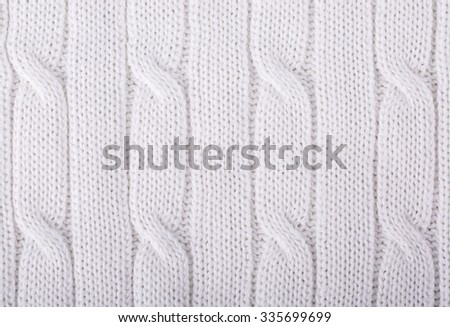 White knitted background. Knitwear fabric texture.