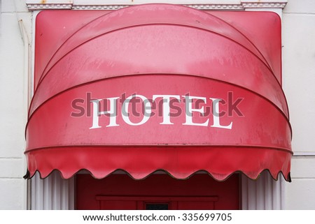 Canopy over the entrance. Red Hotel-sign canopy represents the input.