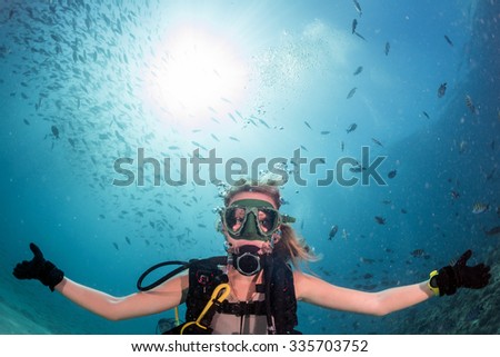beautiful diver blonde girl diving in the deep blue sea