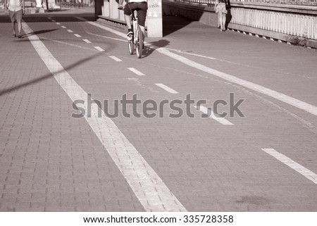 Bike Lane with Cyclist in Urban Setting in Black and White Sepia Tone