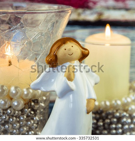 angel and burning candles decoration