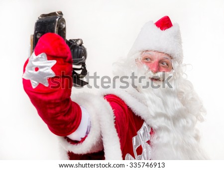Santa Claus with old camera on white background. Isolated