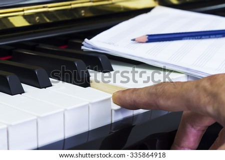 Composer music with Piano and  Record on Staff Paper / Selective focus