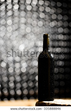 Bottle of red wine in an aging cellar.Close-up