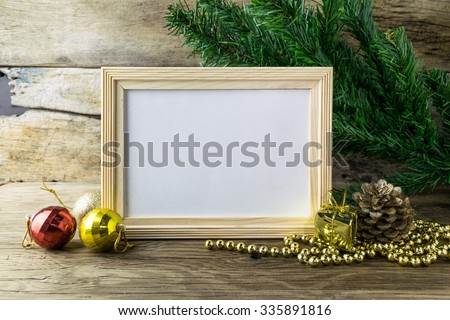 Picture Frame and Christmas decorations on old wooden background. 