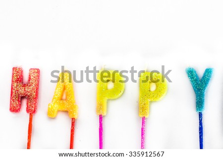 The word Happy candles are arranged on isolated white background