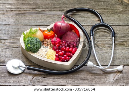 Healthy food in heart and cholesterol diet concept on vintage boards Royalty-Free Stock Photo #335916854