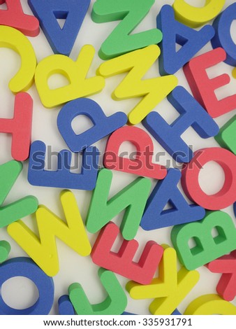 Alphabet background with mixed colorful letters. 