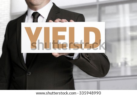 yield sign held by businessman concept.