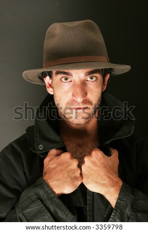 Attractive man in hat and trench coat