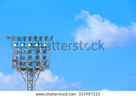 Lighting tower of stadium on sky and cloud background.