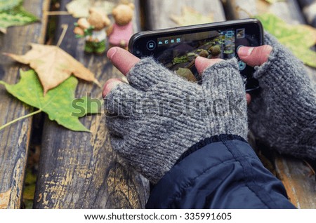 Man shooting autumn on his phone camera