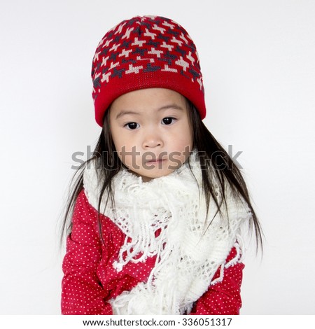Asia little girl in red cozy sweater and red hat, little girl in christmas   