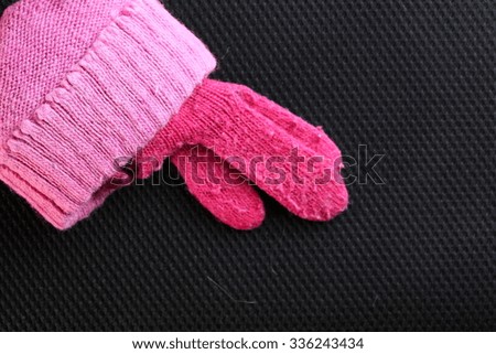 The woolen glove pink color represent the textile and fashion concept related idea.