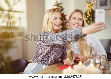 two girls taking a selfie while having christmas dinner at home