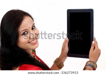 Traditional Indian woman using a tablet computer