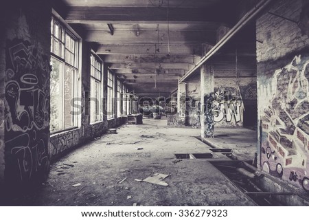 Old abandoned factory hall and graffiti Royalty-Free Stock Photo #336279323